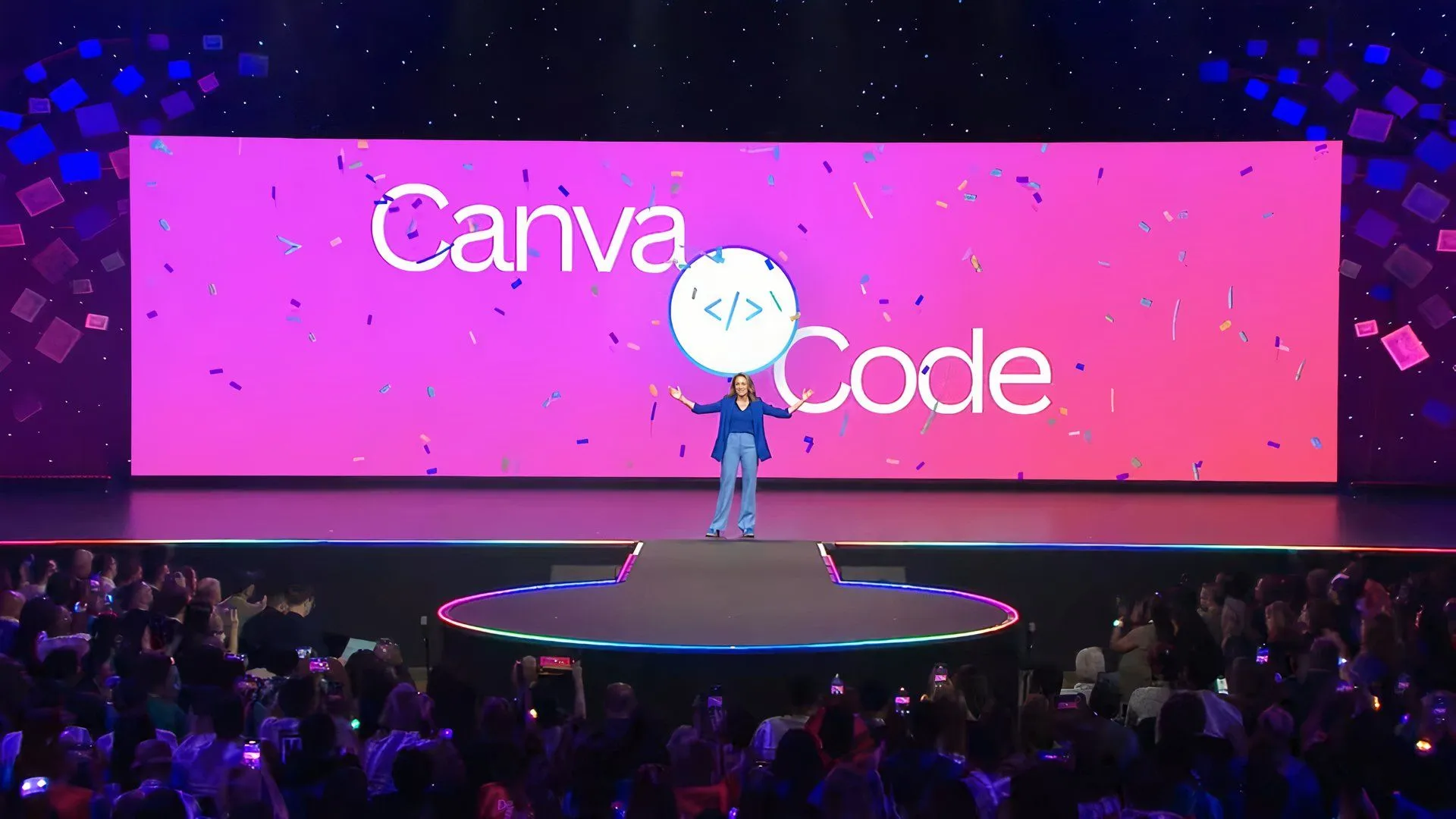 Các diễn giả trên sân khấu công bố tính năng Canva Code mới trên màn hình lớn