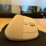 Chuột không dây Logitech đặt trên mặt bàn làm việc.