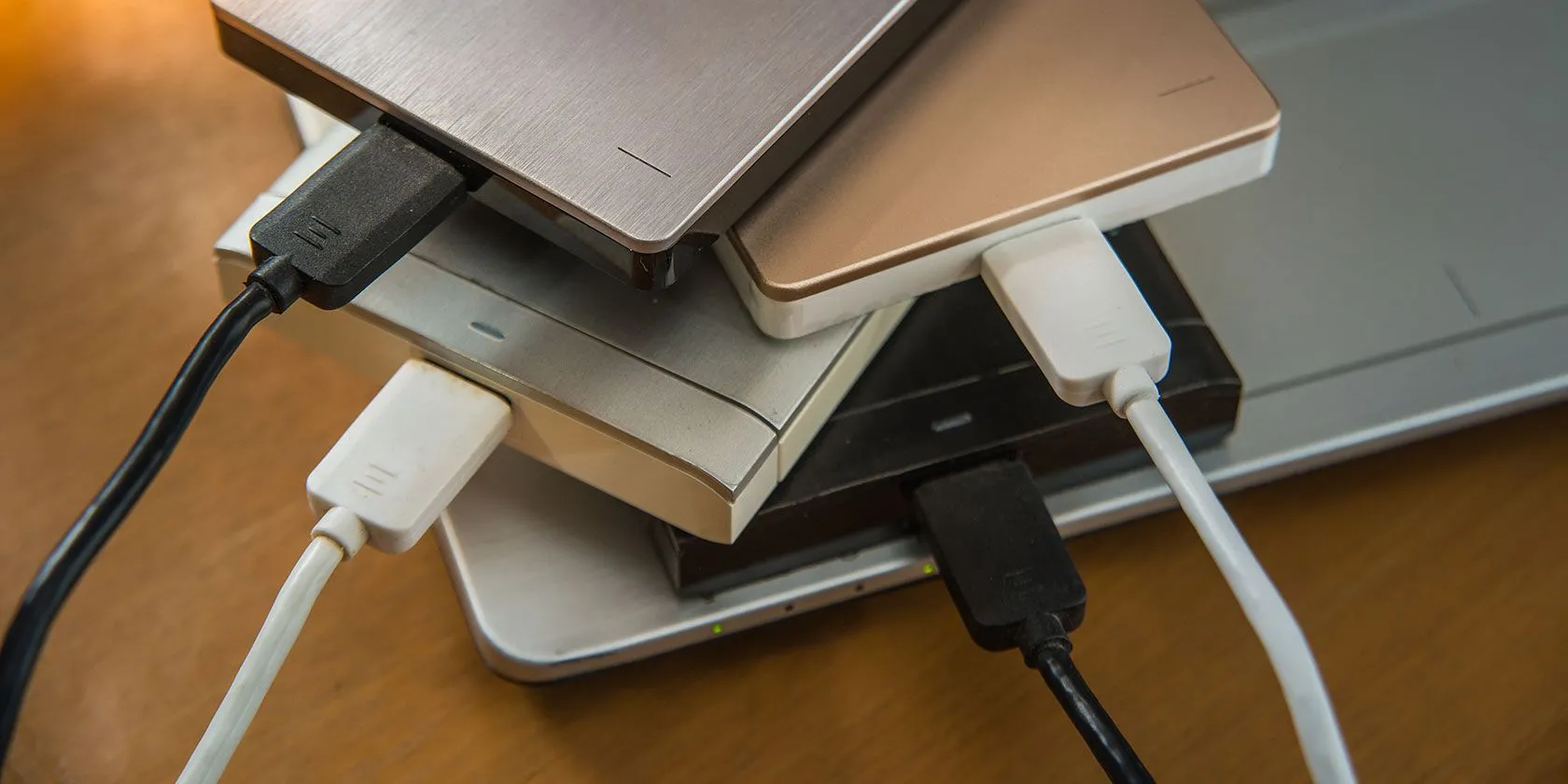 Nhiều ổ cứng di động và SSD ngoài đặt trên laptop, minh họa giải pháp lưu trữ thay thế phân vùng ổ đĩa