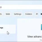 Thanh tìm kiếm Windows 11 mở với từ khóa "view advanced system settings"